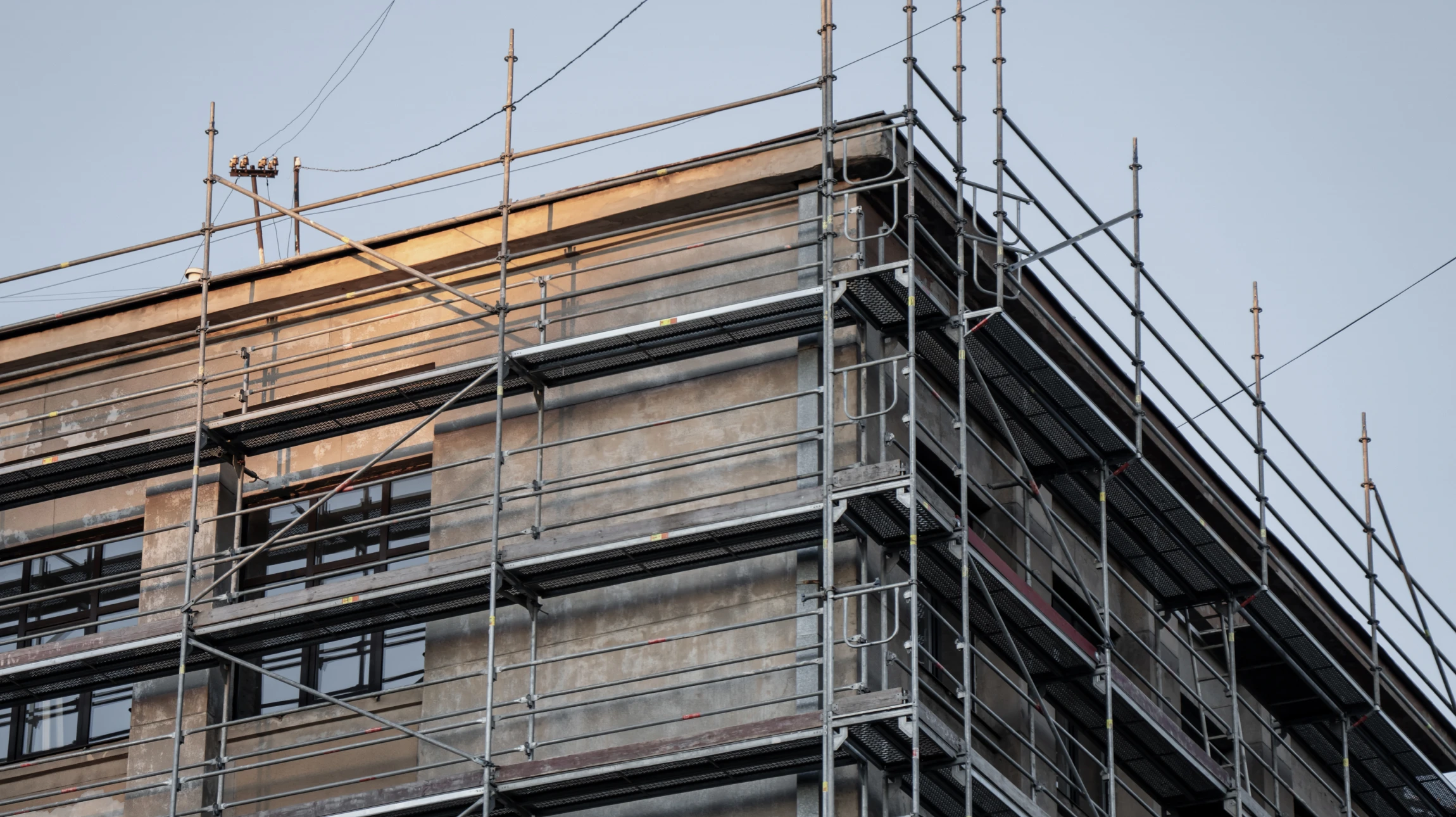 Échafaudage métallique tubulaire installé sur façade d'immeuble résidentiel pour travaux de rénovation